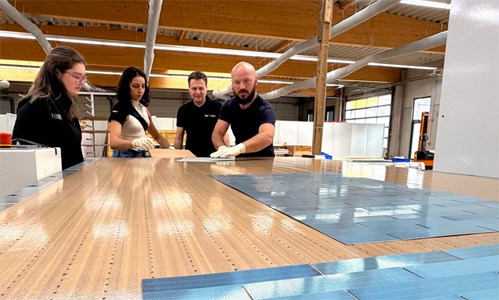 Bryan Mazor, CTO of Source Energy, with colleagues at the industrial shingled matrix stringer of M10 Solar Equipment GmbH. &copy; M10 / Photo: St&eacute;phanie Pigot.