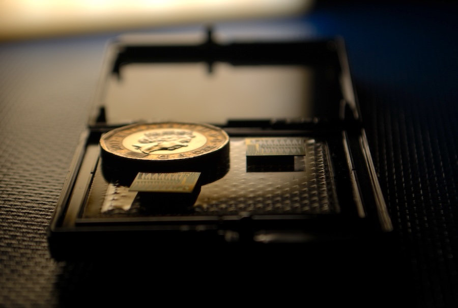 Siloton's first-generation OCT chip (Akepa) with a British Â£1 coin for scale. Akepa replaces approximately 70% of the optics that are found in traditional OCT systems. Credit: Siloton.