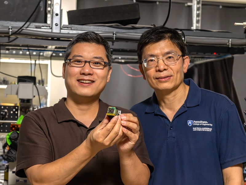 Xingjie Ni, left, associate professor of electrical engineering, displays a camera sensor integrated with a three-millimeter-by-three-millimeter metasurface. The metasurface turns a conventional camera into a hyperspectro-polarimetric camera. Zhiwen Liu, right, co-corresponding author on the paper, is a professor of electrical engineering. Credit: Kate Myers/Penn State.