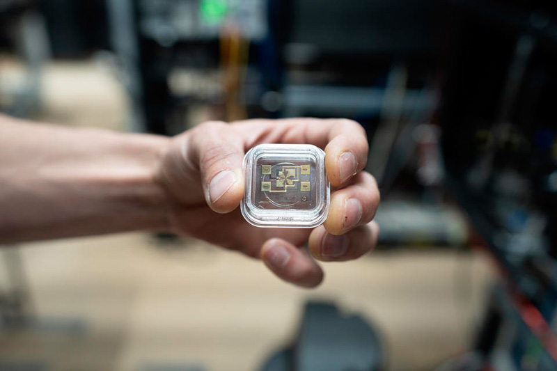 NIST physicist David Hume holds the newly modified ion trap for the aluminum ion clock. By modifying the trap, the aluminum ion and its magnesium ion partner were able to 