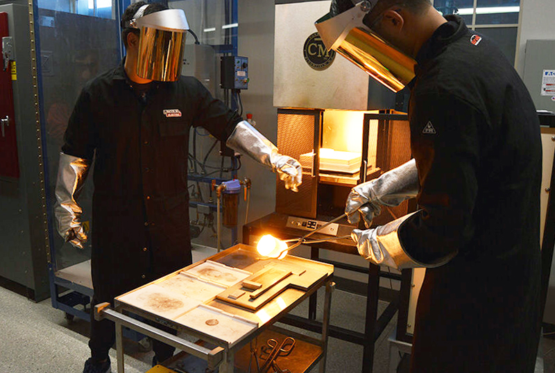 Ye Luo, PSU doctoral student, pours new composition of germanosilicate glass.