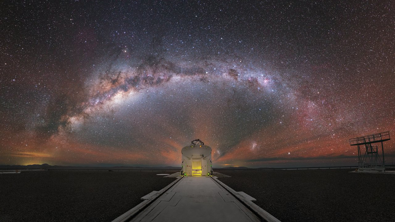 The Milky Way stretched out behind one of the Auxiliary Telescopes of ESO's VLT. The Milky Way stretched out behind one of the Auxiliary Telescopes of ESO's VLT.