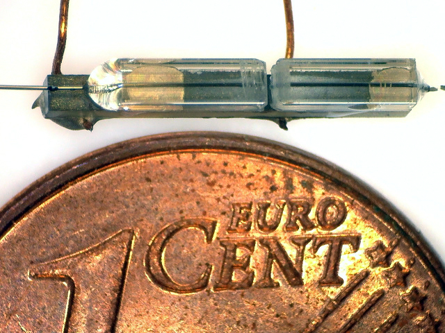 Miniaturised optical filter is located in the central slot of the sleeve mount.