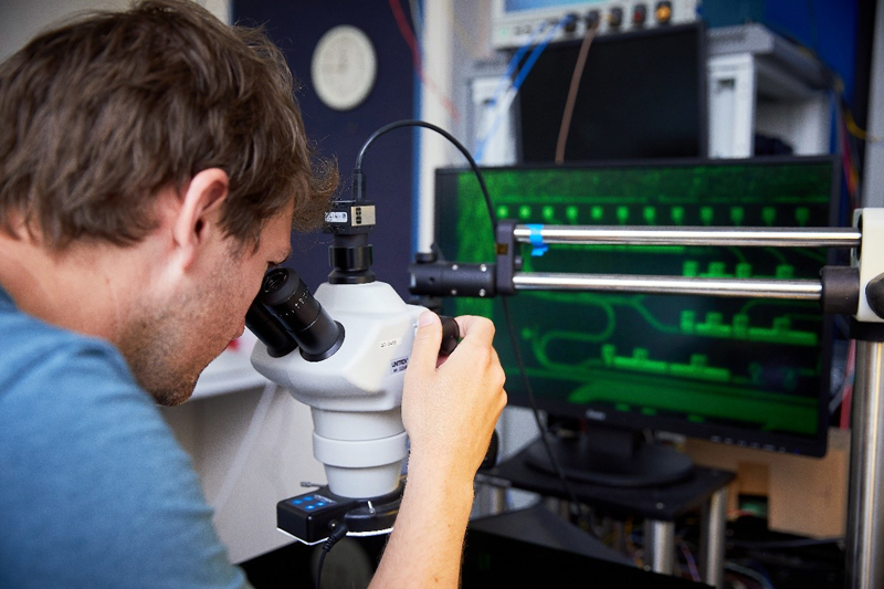 A Toshiba scientist examines a QKD chip.