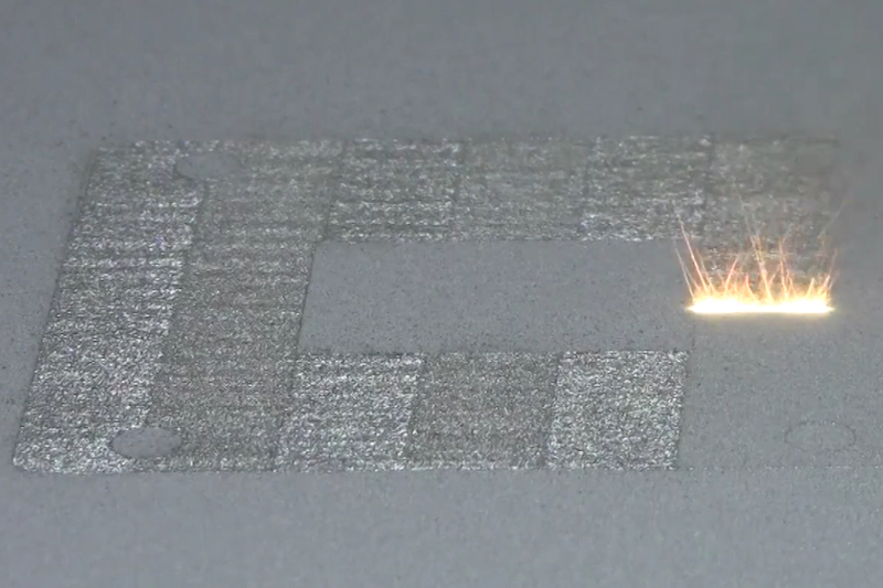 3D printer of the laser powder-bed fusion type, in action.