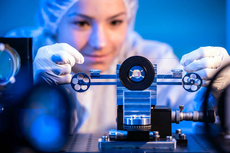 Sarah Klein clamps a fiber for the exposure process.