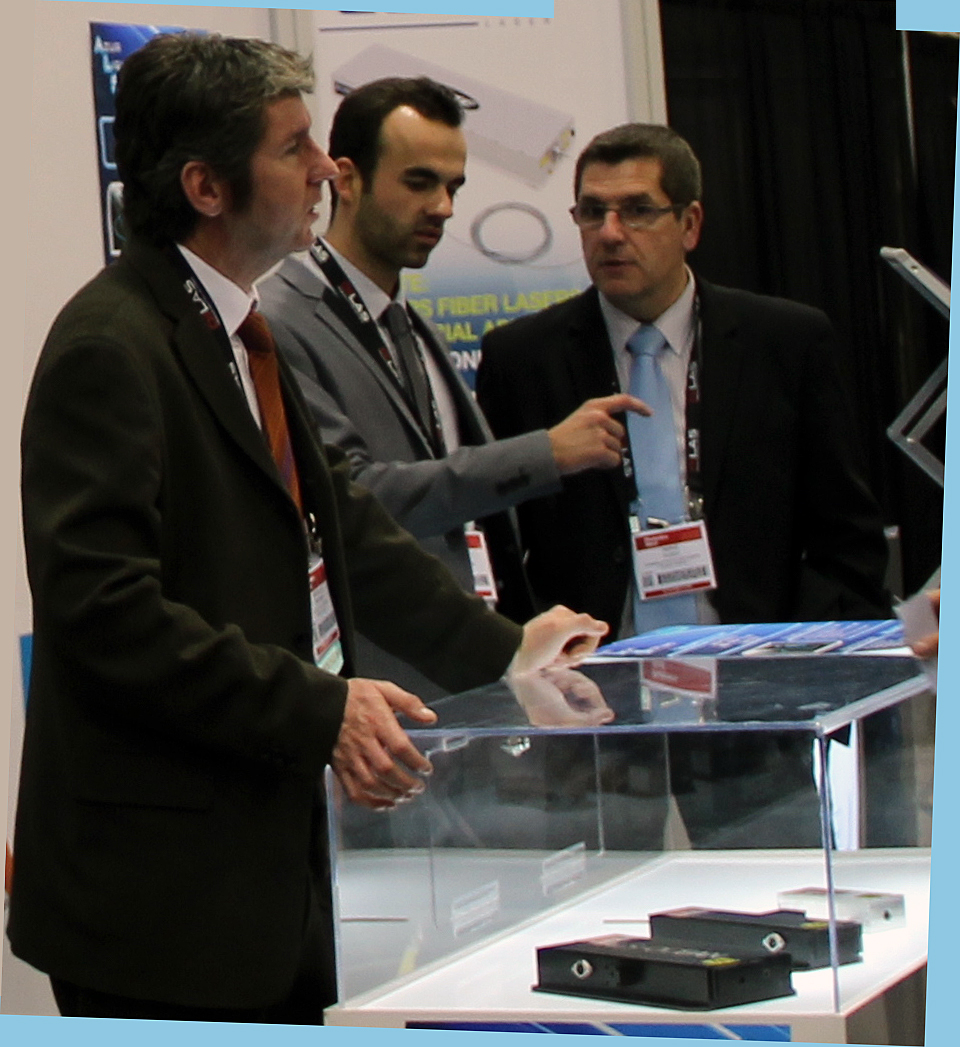 Route des Lasers members discuss opportunities at an exhibition.