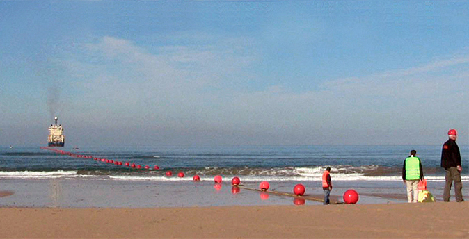 6000km to go: undersea cable-laying starts at the beach.