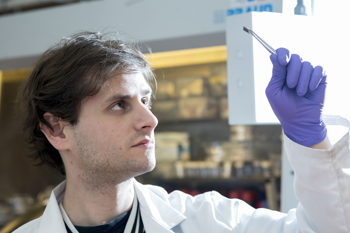 Warwick PhD student Kenny Marshall with a lead free solar cell.