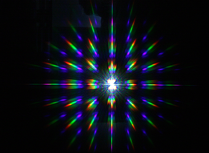 Diffractive image generated by the holographic structure produced on glass. Diffractive image generated by the holographic structure produced on glass.