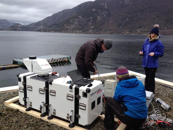 Researchers prepare a long-range lidar laser instrument WindCube100S.