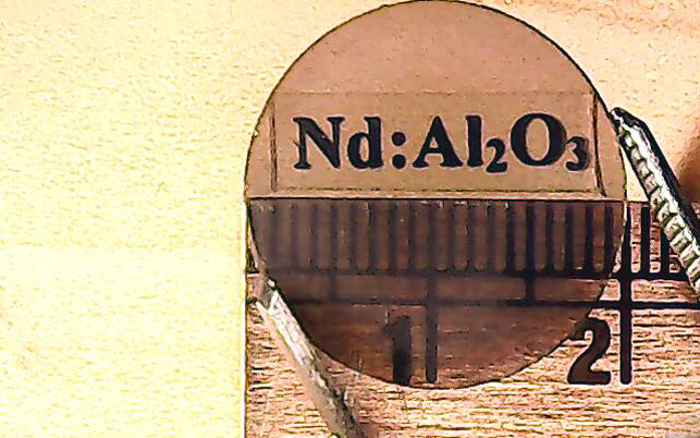 Strong and powerful: disc of neodymium-alumina laser gain material. 