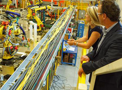 Carolyn Garvey and Don Leslie, CEOs of Prodomax, observe a production line.