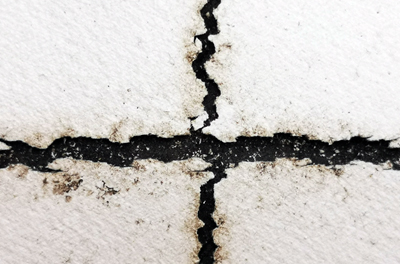 Cracks on solar panel backsheets along the gaps between solar cells.