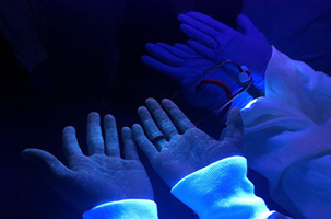 Tell-tale fluorescent liquid visible on healthcare workers’ skin.