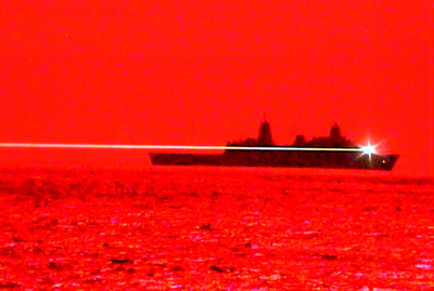 Red for danger: USS Portland fires its laser weapon at the UAV.