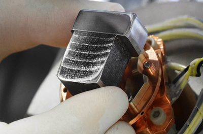 Damascene conversion: composite material with metal layers of varying hardness.