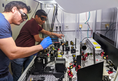 Carlos Saavedra (left) and Deepak Pandey prepare the optical microfilter.