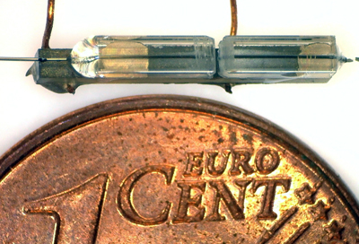 Miniaturised optical filter is located in the central slot of the sleeve mount.