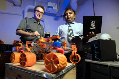 Arizona engineers Moe Momayez and Jekan Thanga with 3D-printed rover prototype.