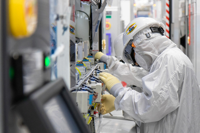 Intel manufacturing employees work in the cleanroom of Fab 34.