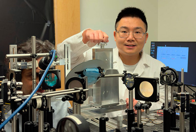 Liu, right, positions the subject, Dr. Palash Bharadwaj, at the ORG system.