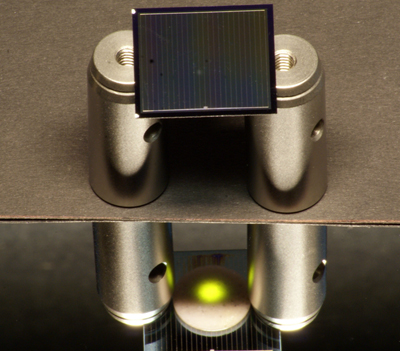 A two-sided silicon solar cell illuminated by an infrared laser.